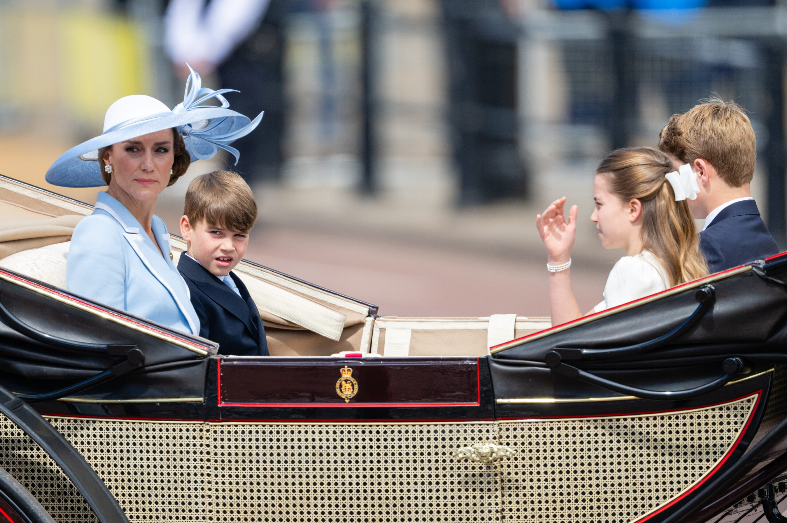 The royal family maintained serious expressions while traveling in the carriage, though the bright sunshine may have contributed to their solemn look. In this photo, Catherine, Princess of Wales, Prince Louis of Wales, Princess Charlotte of Wales, and Prince George of Wales were seen arriving for Trooping the Colour at Buckingham Palace on June 13, 2026, in London, England.