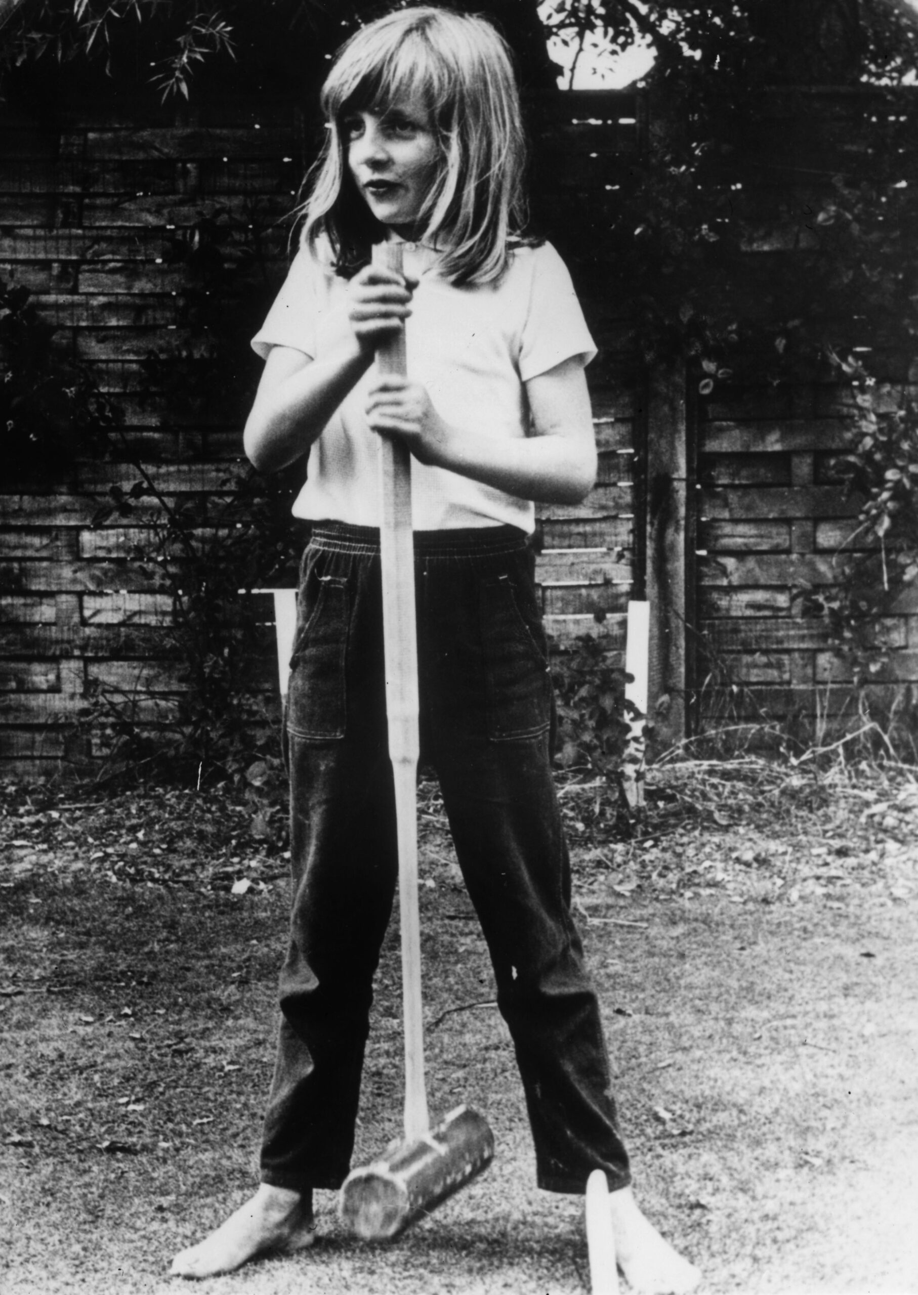 Diana, Princess of Wales, holding a croquet mallet during a game at Itchenor, England, circa 1970.