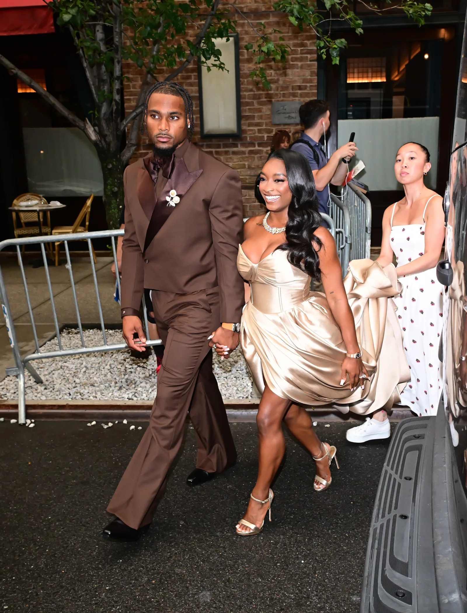 This candid moment captured the couple making their way through the city after the event. With Owens leading the way and Biles smiling beside him, the image adds context beyond the still expressions that fueled so much discussion online.