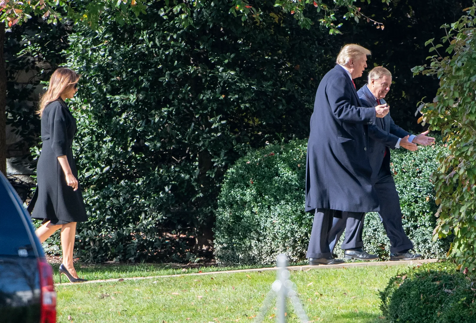 President Donald Trump and Senator Lindsey Graham walk across the White House grounds in November 2018. After Graham's death, Trump called him "like a member of the family" and ordered American flags to be flown at half-staff in his honor.