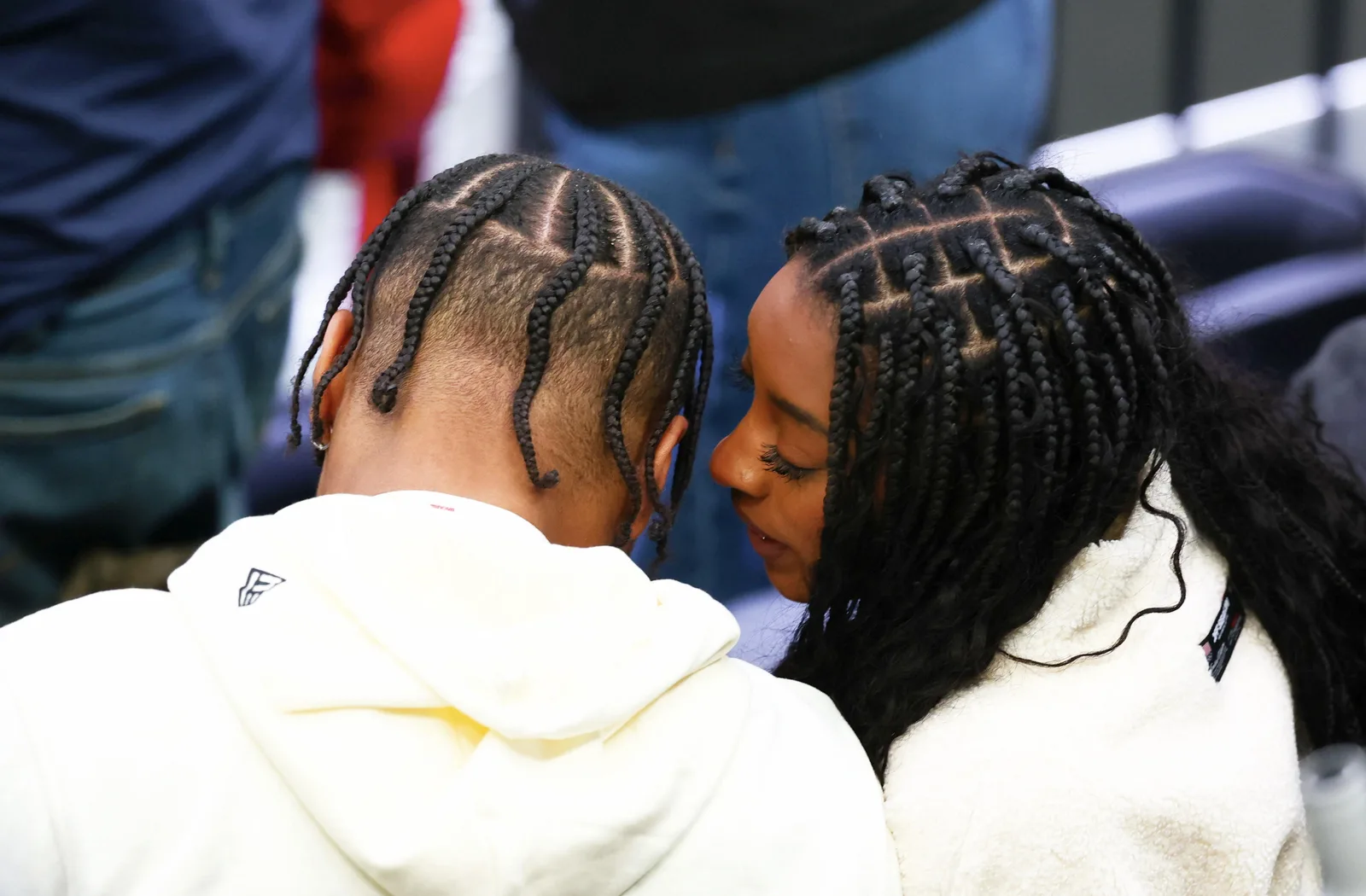 Not every public appearance by the couple takes place on a red carpet. While attending a men's ice hockey playoff quarterfinal at the Milano Cortina 2026 Winter Olympics, they were photographed sharing a moment in the stands.