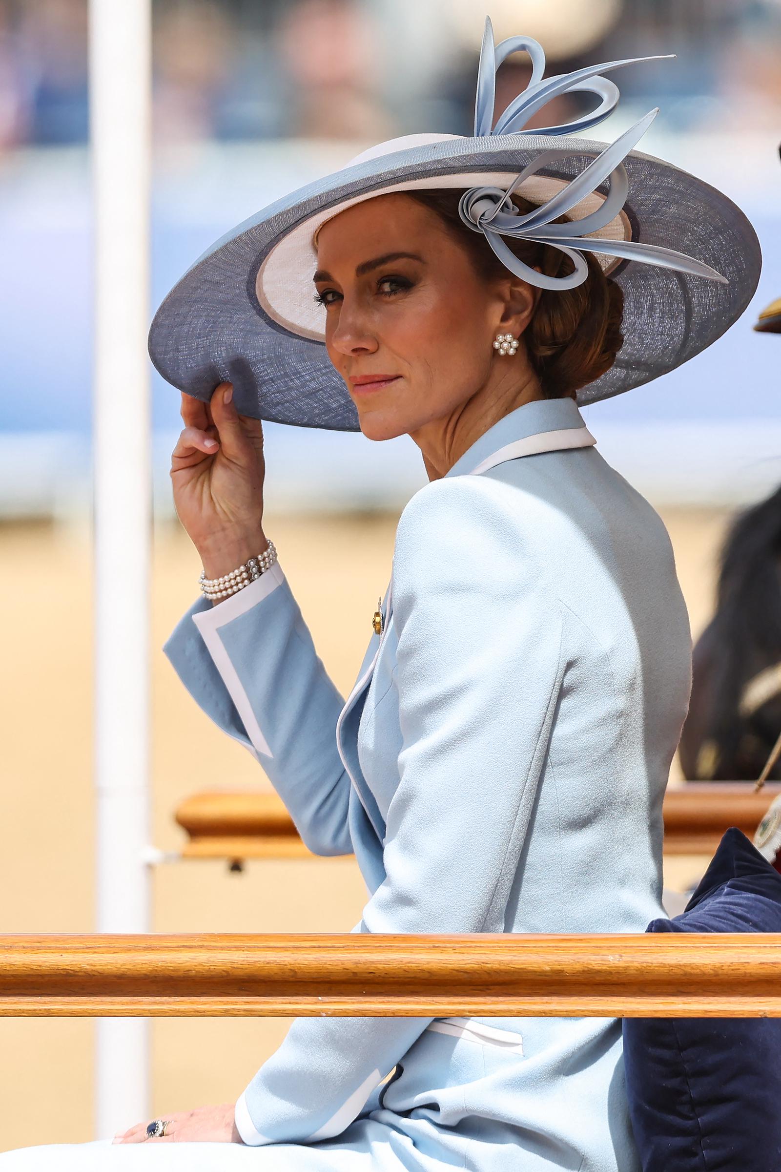 Although some photographs captured Catherine smiling, she maintained a highly serious expression throughout much of the event.