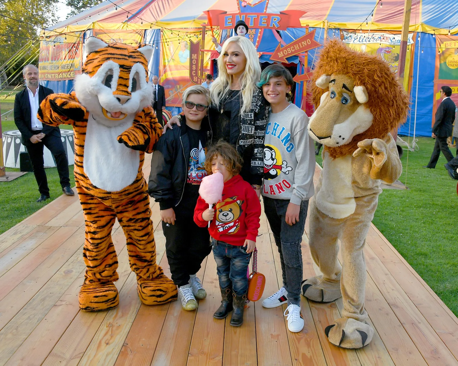 Nine-year-old Zuma Rossdale channeled effortless rockstar energy with his stylish blonde hair, sleek black bomber jacket, and cool sunglasses alongside Gwen Stefani, Apollo Bowie Rossdale, and Kingston Rossdale. At this event, they posed with costumed performers during the Moschino Spring/Summer 19 Menswear and Women's Resort Collection at Los Angeles Equestrian Center on June 8, 2018, in Burbank, California.