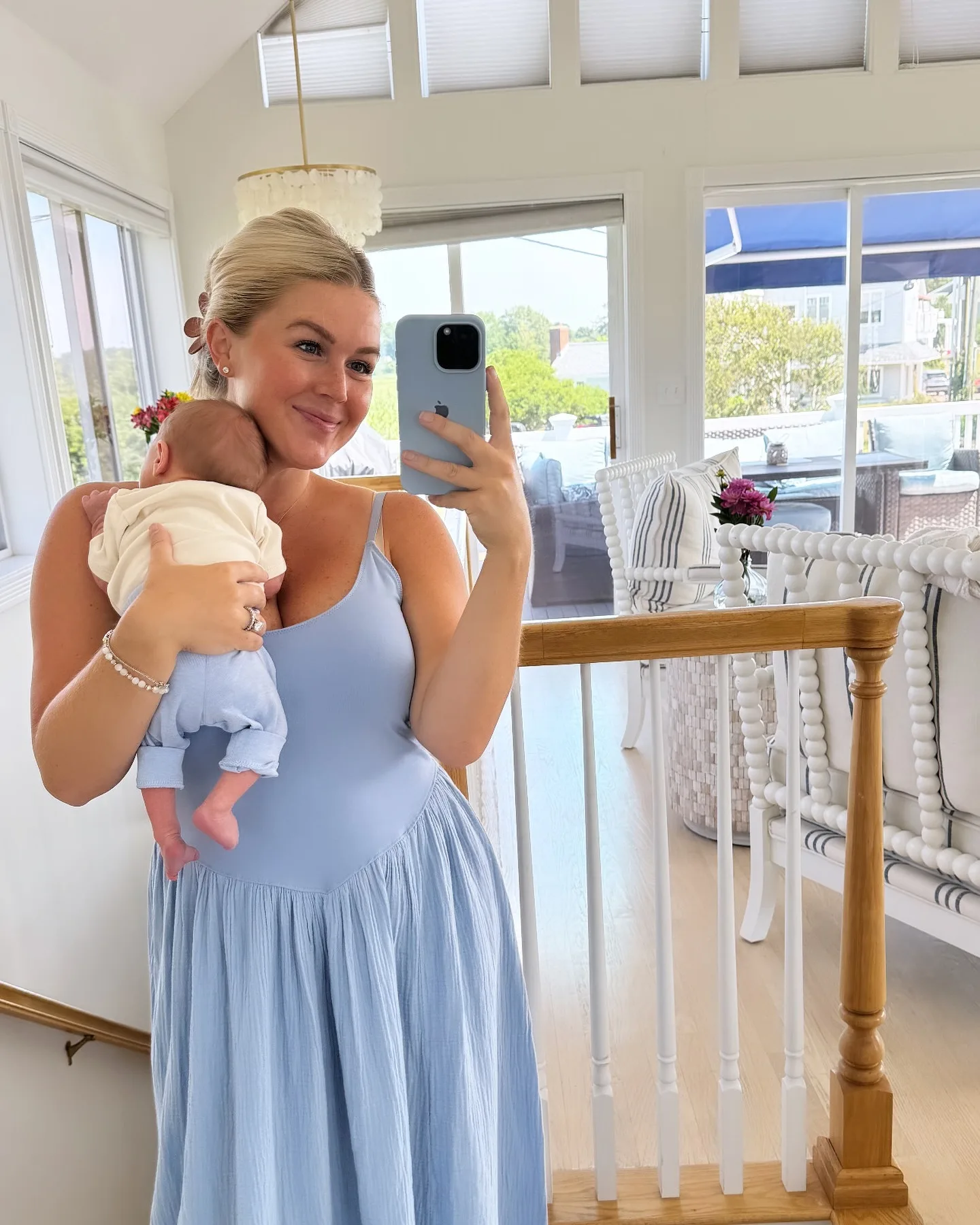 This image offers one of the clearest glimpses of the home's light, airy decorating style, with rows of white furniture and sunshine filling the room behind Leavitt. The pale-blue dress and soft neutral interiors almost echo the color palette found elsewhere in the family's nursery spaces.