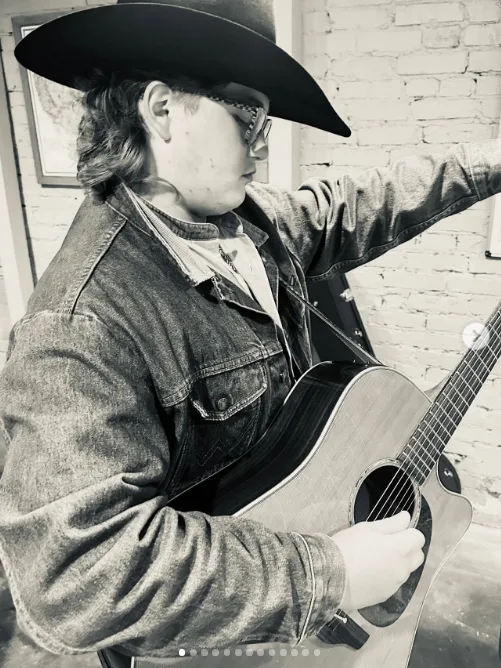 Zuma Rossdale showcased his musical talents while strumming an acoustic guitar in a cowboy hat, glasses, and denim jacket in an image shared on August 21, 2025.