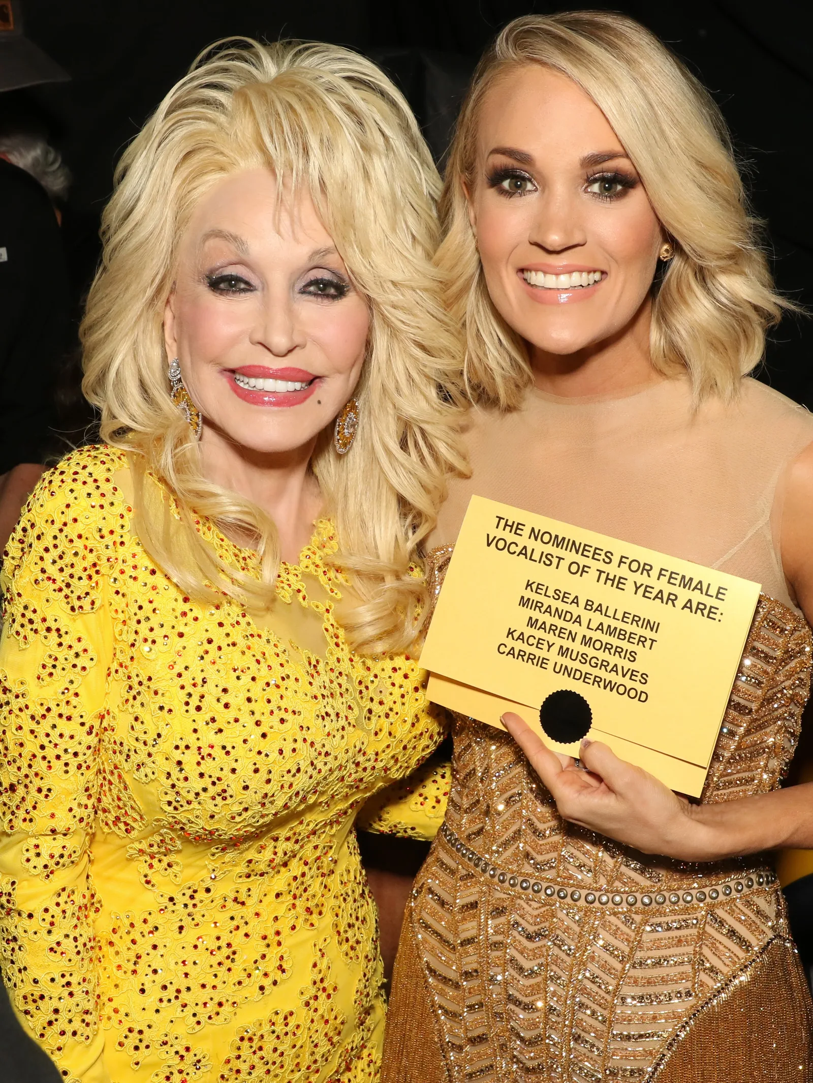 Award Show Support: Parton beams alongside Underwood, who proudly holds up a nominee card for Female Vocalist of the Year backstage.