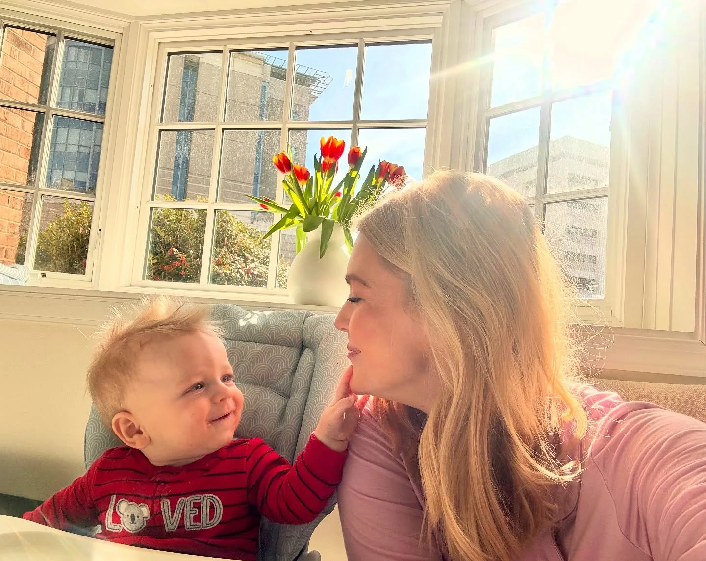 Huge windows are one of the Washington home's recurring visual signatures, and this photo shows exactly how much daylight they bring inside. The warm mother-and-son moment also hints at why Leavitt ultimately decided that time with her children had to take priority.