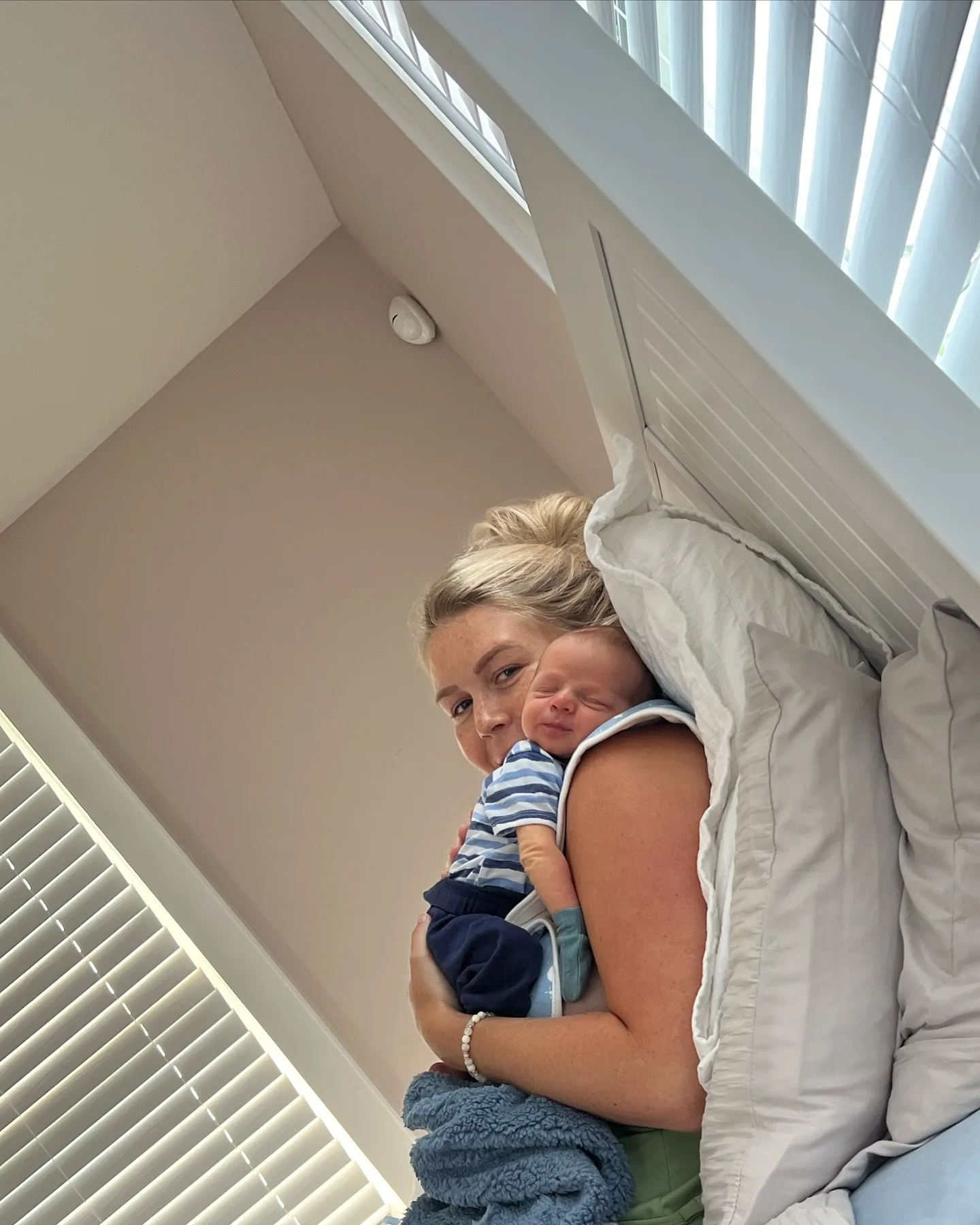 This quiet newborn moment puts the home's soft neutral palette front and center, with white bedding and abundant natural light surrounding mother and baby. It is almost the visual opposite of the crowded briefing room where Leavitt spent so much of her professional life.