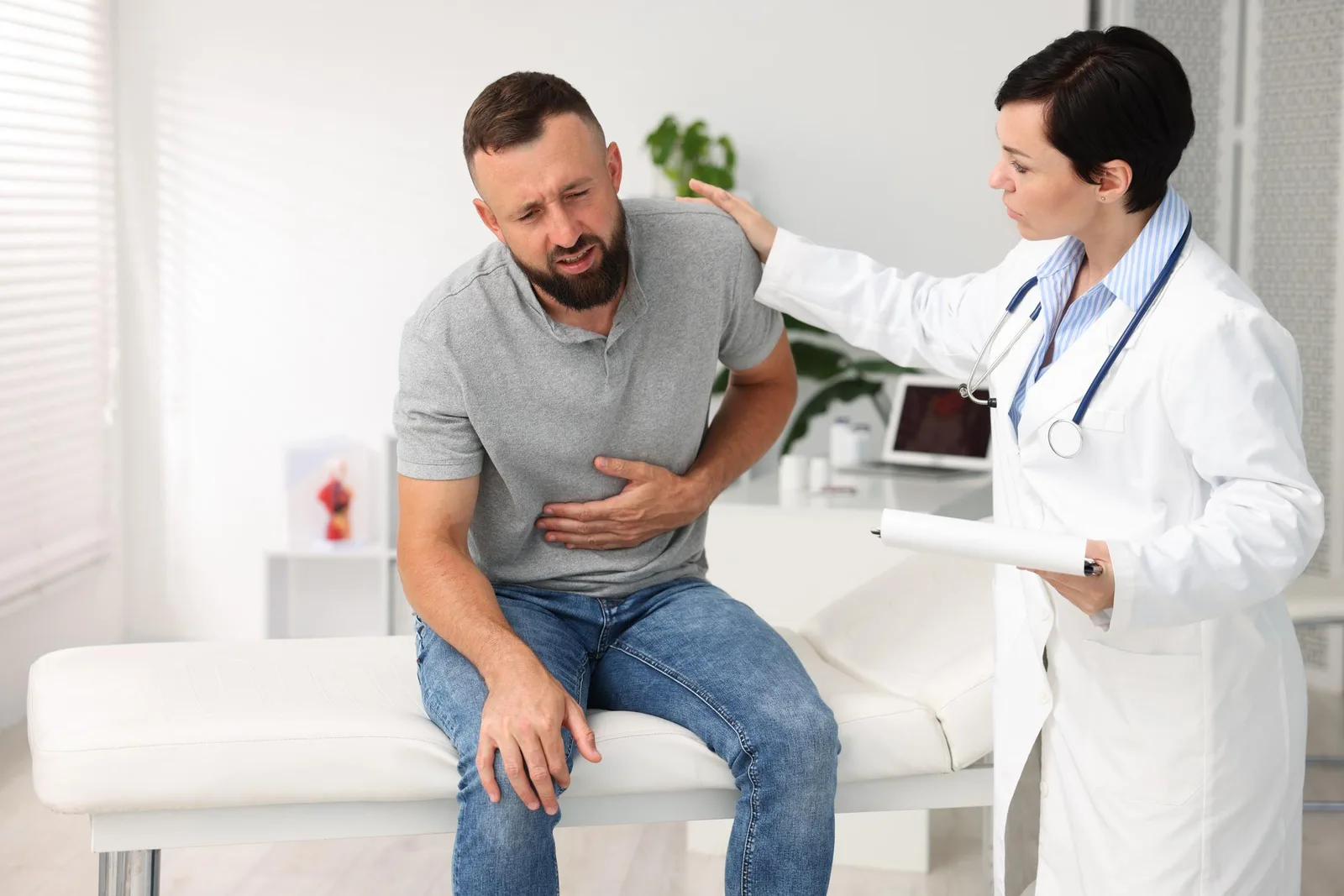 A person experiences abdominal discomfort in an illustrative image. Salmonella infection can cause symptoms including diarrhea, fever, stomach cramps, nausea, and vomiting after consuming contaminated food.