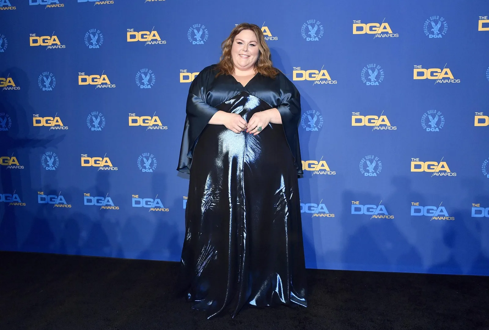 Metz posed in a dark navy gown with a glossy satin finish at the Directors Guild of America Awards. The image marks another stage before her later focus on strength training and GLP-1 treatment.