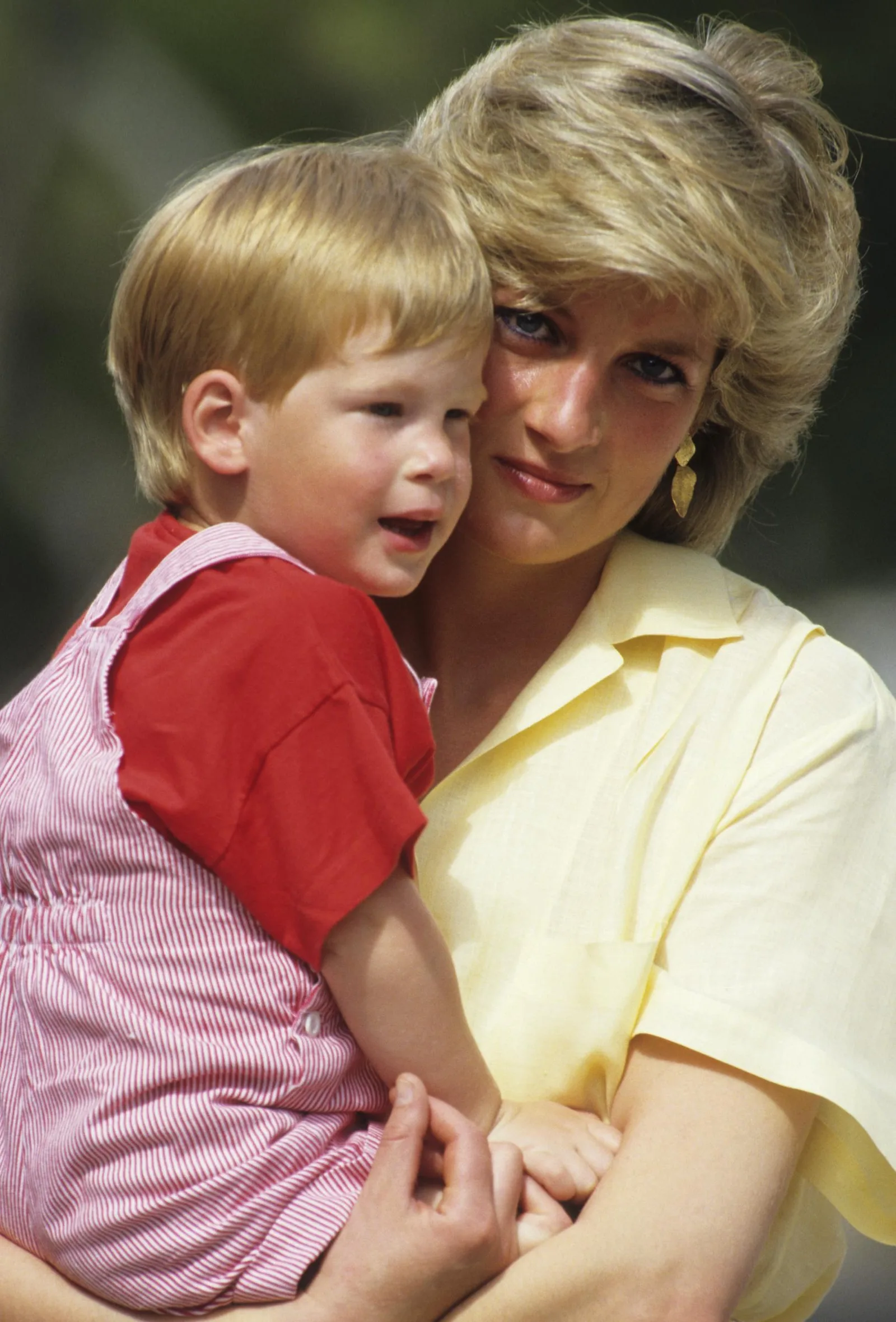 Princess Diana holds a young Prince Harry during a family holiday in Majorca, Spain, in August 1987. Decades later, a source said Diana's legacy remains an influence on Harry as tensions with the Royal Family continue.