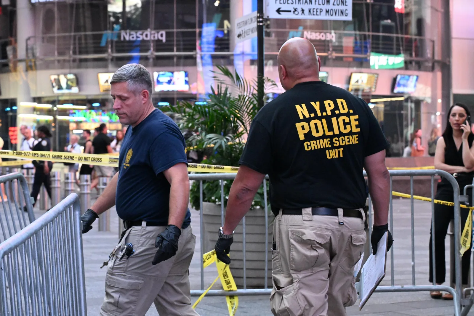 NYPD crime scene investigators worked behind police tape after the violence near Seventh Avenue in Times Square. The police response later drew questions from Cisernos' family, including her mother's pointed question about why officers did not grab her by the arm.
